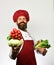 Cook with proud smile in uniform holds cabbage and radish