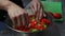 The cook puts chopped vegetables in a bowl to prepare a cataplan. Horizontal video