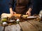 The cook rolls out the dough with a rolling pin on a wooden cutting board. Lots of ingredients for making a delicious pumpkin pie