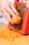 Cook rubs carrots on a grater