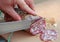 Cook\'s hand slicing the salami