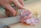 Cook\'s hand slicing the salami