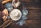 The cook's hand stirs the leaven. Flour, sourdough, water, wheat on a wooden background.