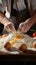 Cook\\\'s hands expertly incorporating an egg into a flour pile for cooking