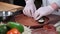 Cook serving delicious Japanese sushi rolls on a wooden plate