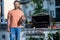 cook showcasing his barbecue techniques at cookout event. Man enjoying barbecuing. man grilling his favorite meats, copy