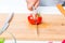 Cook sliced a ripe tomato in two parts on wooden board