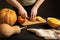 The cook slices the pumpkin for baking.