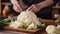 Cook slicing a Cauliflower into slices