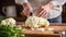 Cook slicing a Cauliflower into slices