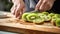 Cook slicing kiwis in a kitchen