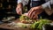 Cook slicing a sandwich into two parts in a kitchen