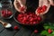 The cook sorts through fresh raspberries before preparing a sweet fruit drink. Close-up of a chef hands while working