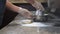 Cook sprinkling flour on dough and the cooking table surface to knead