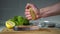 The cook squeezes the lemon juice on the steak.