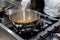 A cook stirring pots in the kitchen. Big pots in the kitchen