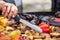 Cook turns the culinary nippers fried vegetables on the grill.