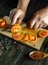A cook uses a knife to cut tomatoes to add to a vegetarian meal. Vegetable diet idea