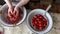 The cook washes ripe tomatoes with water