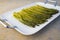 Cooked asparagus on a white plate