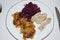 cooked bacon with red cabbage and fried potatoes