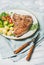 Cooked beef tbone steak with vegetables and rosemary in plate