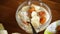 cooked boiled sweet oatmeal with with dried apricots and bananas in a bowl