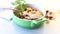 cooked boiled sweet oatmeal with nuts and candied fruits in a bowl