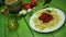 Cooked bows pasta on white plate with spinach and tomato sauce.