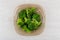 Cooked broccoli in transparent brown plate on wooden table