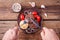 Cooked burger meat on wooden background with mens hands with fork and knife