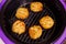 cooked chicken meatballs on steel grille in opened airfryer