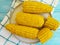 Cooked corn, a plate autumn healthy delicious fresh natural agriculture ingredient food appetizer on a blue wooden background,