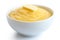 Cooked cornmeal polenta with butter in white ceramic bowl isolated on white.