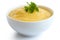 Cooked cornmeal polenta with green parsley in white ceramic bowl