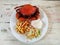 Cooked crabs on white plate served with salad and french fries,