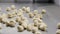 Cooked dumplings flying towards the table from metal pan in slow motion, cooking theme. Making Dumplings by hands