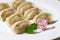 Cooked dumplings on white plate, handmade jiaozi, Chinese traditional flour food