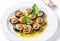 Cooked Escargots De Bourgogne snails with garlic butter and parsley on a plate in a restaurant, delicious and healthy food,