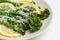 Cooked fresh broccolini with grated cheese on the plate