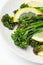 Cooked fresh broccolini with lemon on the plate