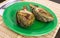 cooked fried halves artichokes on green plate