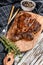 Cooked grilled Chuck eye roll steak on a chopping Board. White background. Top view