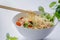Cooked instant noodles sprinkled with spices, vegetables, herbs