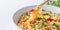 Cooked instant noodles sprinkled with spices, vegetables, herbs