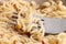 Cooked instant vermicelli in bowl and fork closeup