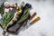 Cooked mackerel icefish on a wooden cutting board. Black background. Top view. Copy space