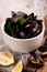 Cooked mussels in a withe bowl