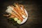 Cooked Organic Alaskan King Crab Legs with Butter and lemons, Alaskan King Crab on vintage wooden background.