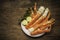 Cooked Organic Alaskan King Crab Legs with Butter and lemons, Alaskan King Crab on vintage wooden background.